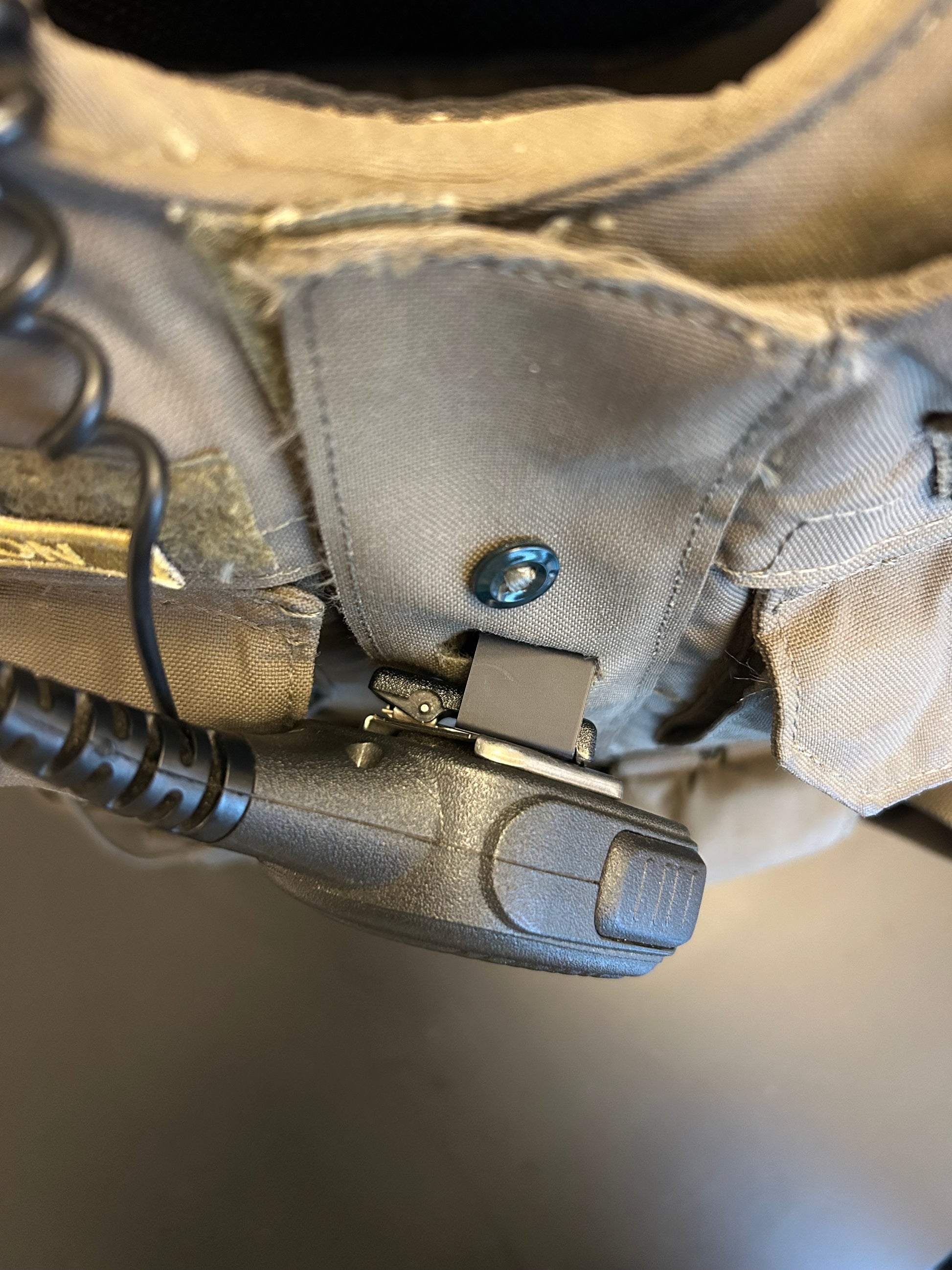 Tactical vest with mic attached to molle microphone clip