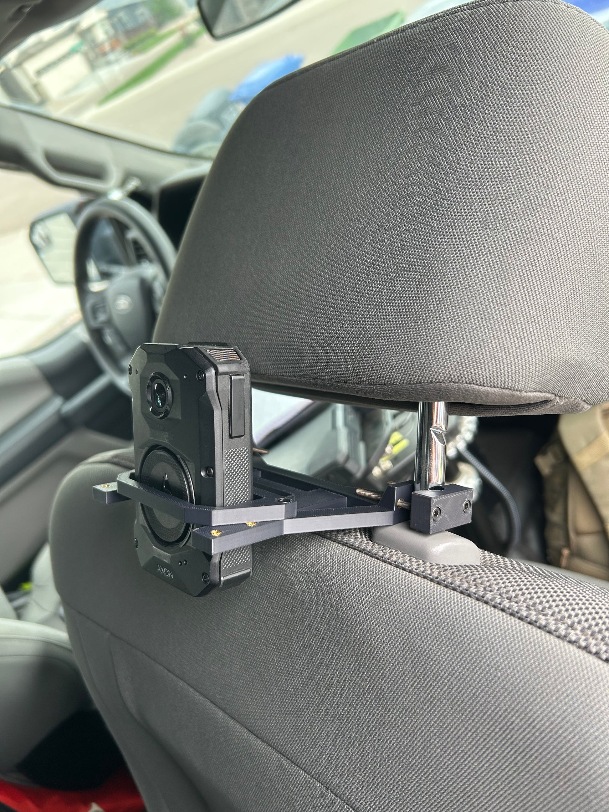 Axon Body Camera being held in Body Camera Vehicle Mount