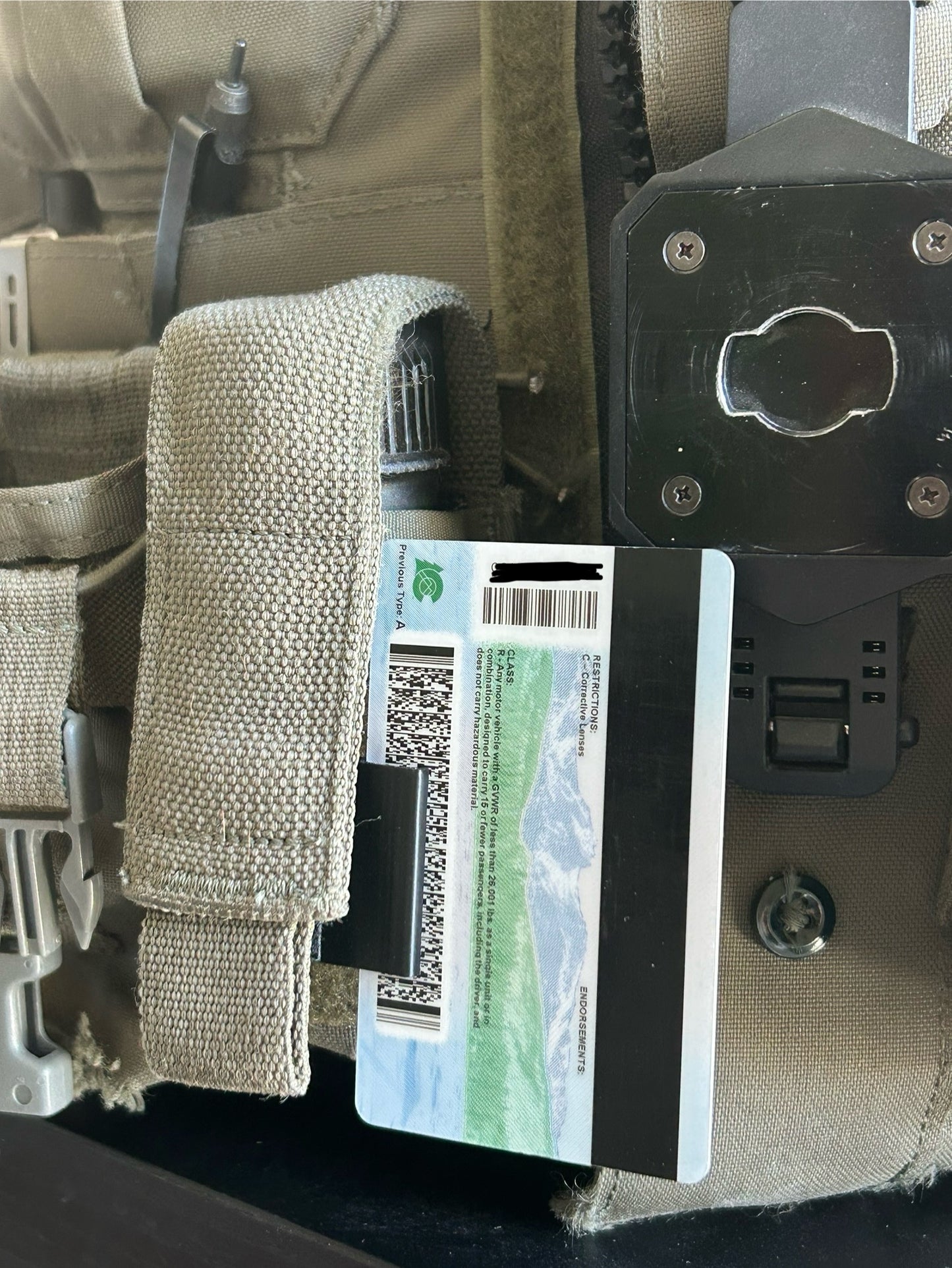 Close-up of a tactical pouch with a card holder attached, showing a close-up of the ID card holder.